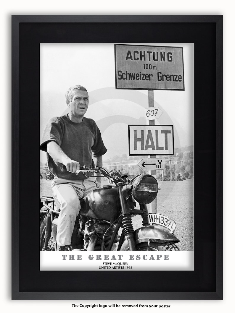 May include: Black and white framed poster featuring Steve McQueen on a motorcycle from "The Great Escape." The poster includes the film title, credits, and German signage reading "Achtung" and "Schweizer Grenze."