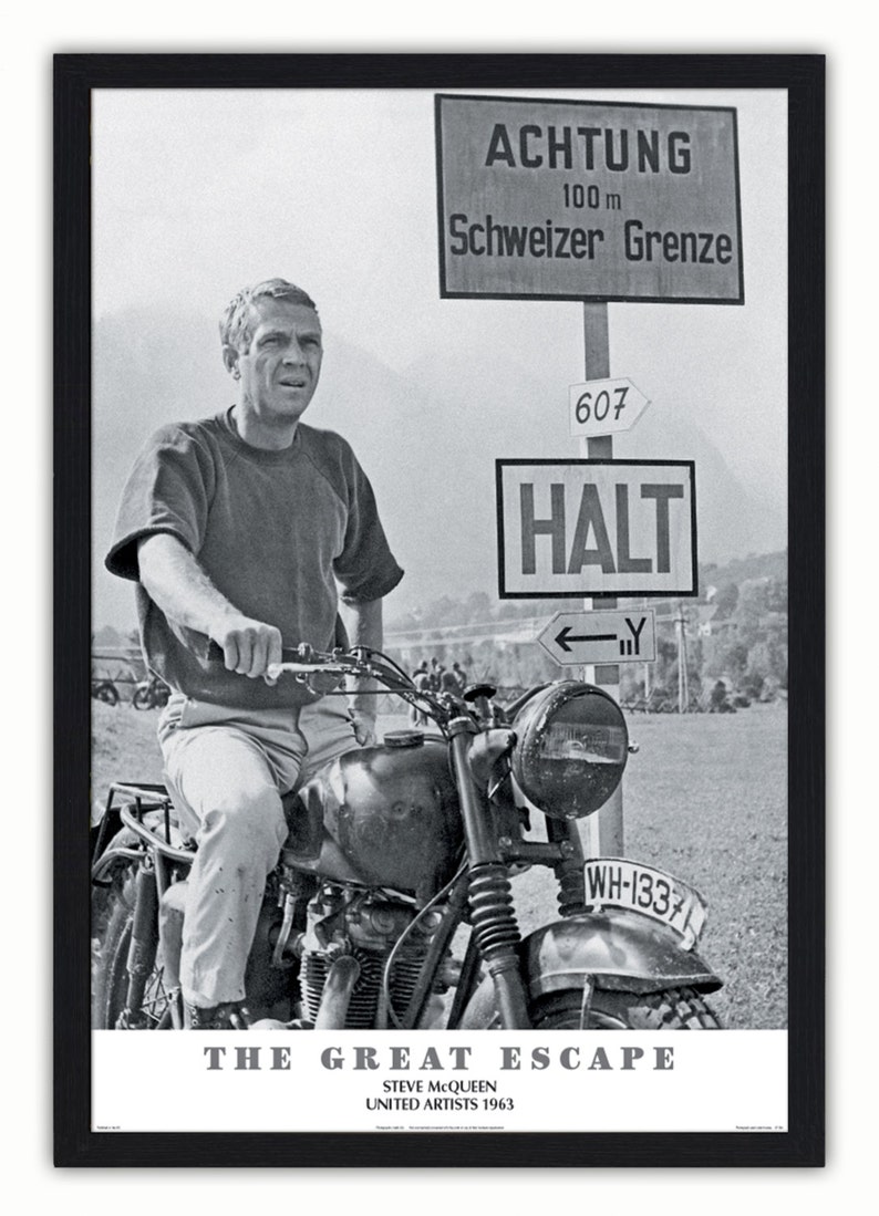 May include: Black and white framed poster featuring Steve McQueen on a motorcycle. The poster includes the text "ACHTUNG", "Schweizer Grenze", and "HALT". The title "THE GREAT ESCAPE" and the year "1963" are also visible.