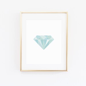 May include: A framed print of a geometric teal diamond shape on a white background.