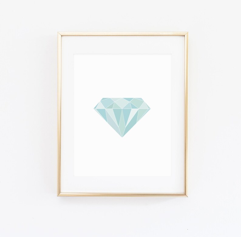 May include: A framed print of a geometric teal diamond shape on a white background.