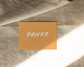 Postcard "DANKE" lettering white printed on natural cardboard curry - DIN A6 by Chilli und Jens