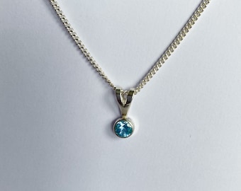 Silver Pendant set with 5mm Blue Topaz with Chain