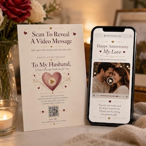 May include: A rectangular anniversary card with cream paper, red heart accents, and text reading Scan To Reveal A Video Message To My Husband. A QR code is printed at the bottom. Next to it, a smartphone displays a video player with a couple.