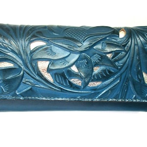 May include: A teal leather wallet with a detailed floral design. The wallet features a fold-over flap and intricate embossed patterns of leaves and flowers. The interior reveals a lighter, contrasting color.