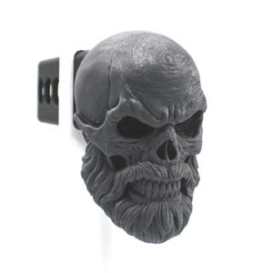 May include: A dark gray hitch cover featuring a sculpted human skull with a detailed beard and mustache. The skull has deep-set eye sockets, a prominent brow, and visible teeth. The hitch cover is attached to a black metal square mounting bracket.