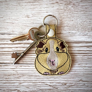 Guinea Pig key fob, embroidered faux leather.