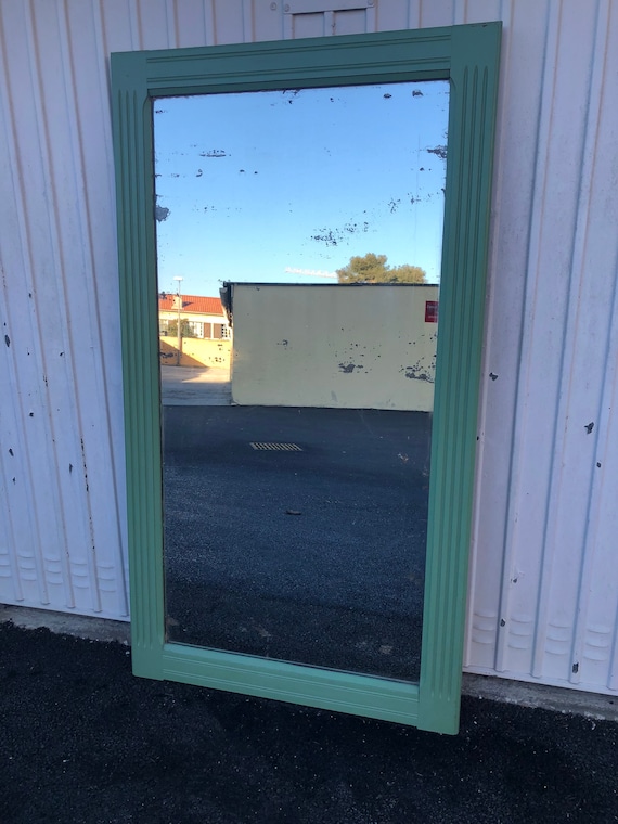 Large old mirror patinated in green