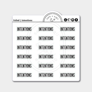 May include: A sheet of 12 foiled stickers with the word "INTENTIONS" printed in black on each sticker. The stickers are arranged in three rows of four. The stickers are on a white background.
