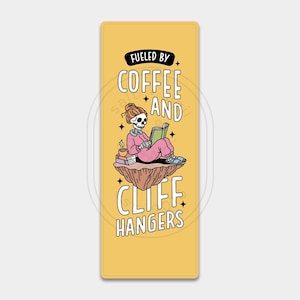 May include: A yellow bookmark with a skeleton sitting on a cliff, reading a book and drinking coffee. The bookmark says "Fueled by coffee and cliffhangers".