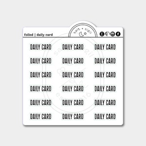 May include: A sheet of 15 foiled stickers with the text "DAILY CARD" repeated on each sticker. The stickers are white with a light green outline and black text. The sheet also includes a small logo with the text "salt + sigil" and a crescent moon.