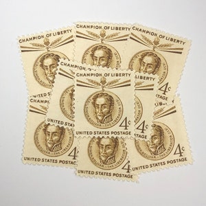 May include: A collection of eight vintage United States postage stamps featuring a portrait of Simon Bolivar, the Liberator. The stamps are beige with brown ink and feature the text "Champion of Liberty" and "United States Postage".