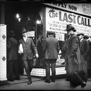 May include: A black and white photo of a store front with a sign that reads 