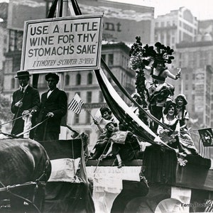 May include: A black and white photo of a parade float with a sign that reads 