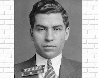 May include: Black and white mugshot of a man with a short, wavy hairstyle. He is wearing a suit and tie. The mugshot has a number tag with the number 72321.
