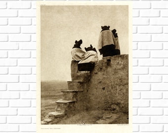 May include: A black and white photograph of four people wearing traditional clothing standing on a stone wall. The people are looking out at a distant landscape. The image is titled "Watching the Dancers".