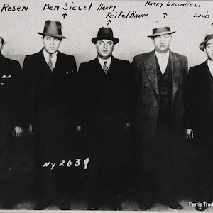 May include: Black and white photo of five men in suits and hats. The men are standing in a line, and their names are written above them. The text "NY 2039" is written below them.