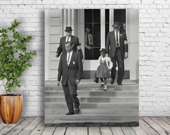 May include: Black and white photo of four people, including a young girl, walking down a set of stairs. The girl is wearing a dress and carrying a small bag. The adults are wearing suits and hats.
