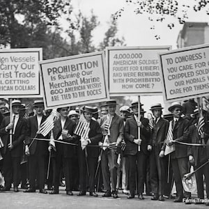 May include: A black and white photo of a group of men holding signs protesting prohibition. The signs read: 