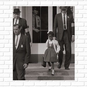 May include: A young girl in a white dress and a black jacket walks up the steps of a school building, escorted by two men in suits. The men are wearing badges that say "Deputy U.S. Marshal".