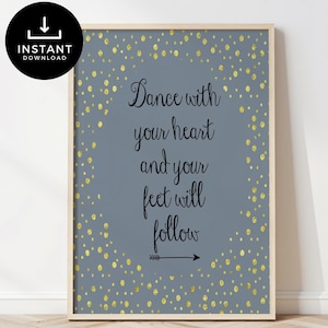 May include: A printable wall art print with a grey background and gold confetti. The print features the quote "Dance with your heart and your feet will follow" with a black arrow pointing to the right.