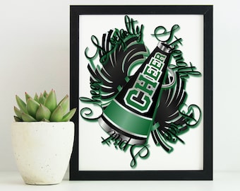 May include: A black and green megaphone with the word "CHEER" on it. The megaphone is surrounded by black and white pom-poms. The words "Spirit, Strength, and Pride" are written around the megaphone.