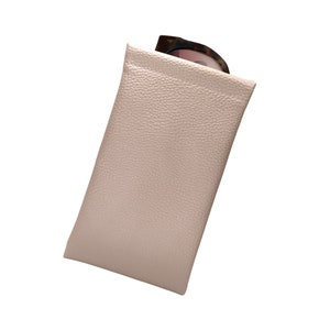 May include: A light pink leather case for sunglasses.