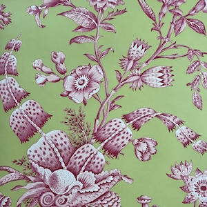 May include: A repeating pattern of stylized burgundy flowers and foliage on a light green background. The floral design features detailed petals, leaves, and stems, creating a vintage aesthetic. The pattern is suitable for wallpaper or fabric.