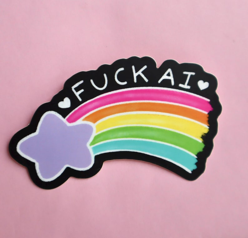 A sticker of a purple shooting star with a rainbow tail that has the works "F-ck AI" above it with two hearts on either side of the text.