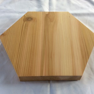 May include: A natural wood hexagonal serving tray with a smooth, light brown finish.