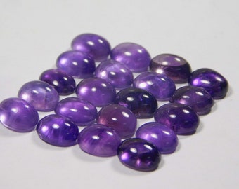 May include: A collection of 18 oval-shaped amethyst gemstones, each with a smooth, polished surface and a deep purple hue.
