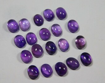 May include: A collection of 18 oval-shaped amethyst gemstones, ranging in shades of purple. The stones are smooth and polished, with a glossy finish.