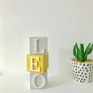 Mustard, light grey and white 5cm wooden name blocks for babies and children.