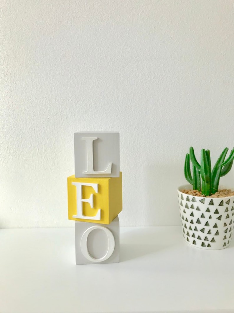 Mustard, light grey and white 5cm wooden name blocks for babies and children.