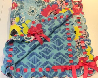 Floral fleece blanket with scalloped edge and pink ribbon