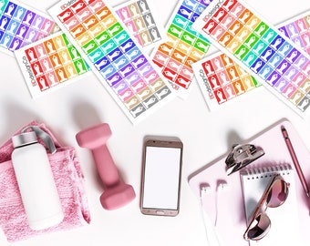 May include: An overhead shot features fitness-themed stickers in various colors, a pink dumbbell, a smartphone, a water bottle, and a pink notepad with accessories. The stickers have a yoga pose design. The items are arranged on a white surface.