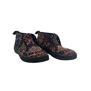 May include: A pair of ankle boots featuring a multi-colored woven tapestry pattern in shades of red, blue, and black. The boots have a rounded toe, a lace-up front with metal eyelets, and a solid black rubber sole with a low heel profile.