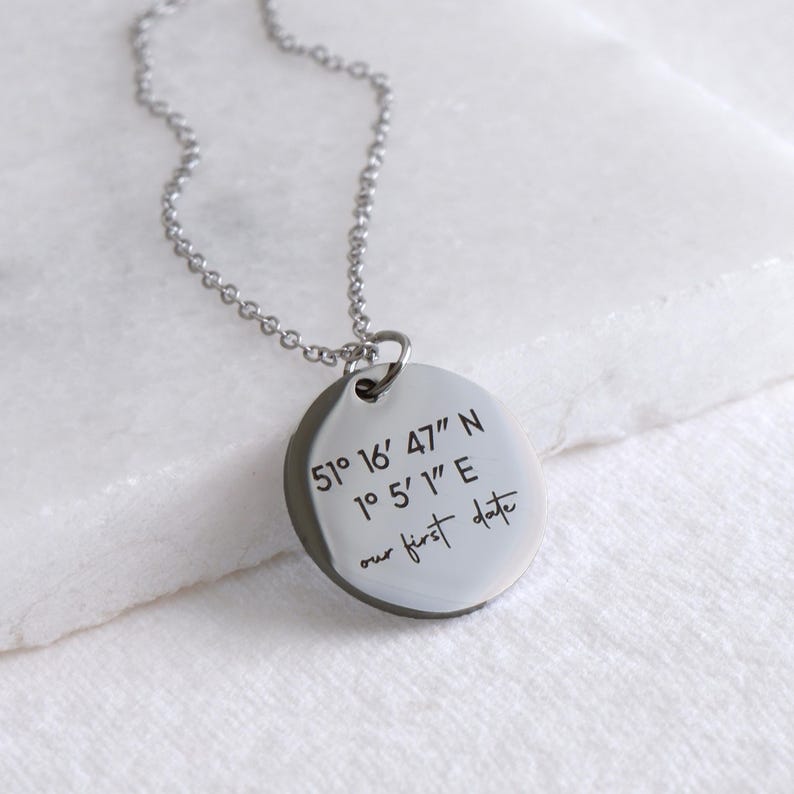 Silver coordinates necklace with engraved latitude and longitude on round pendant