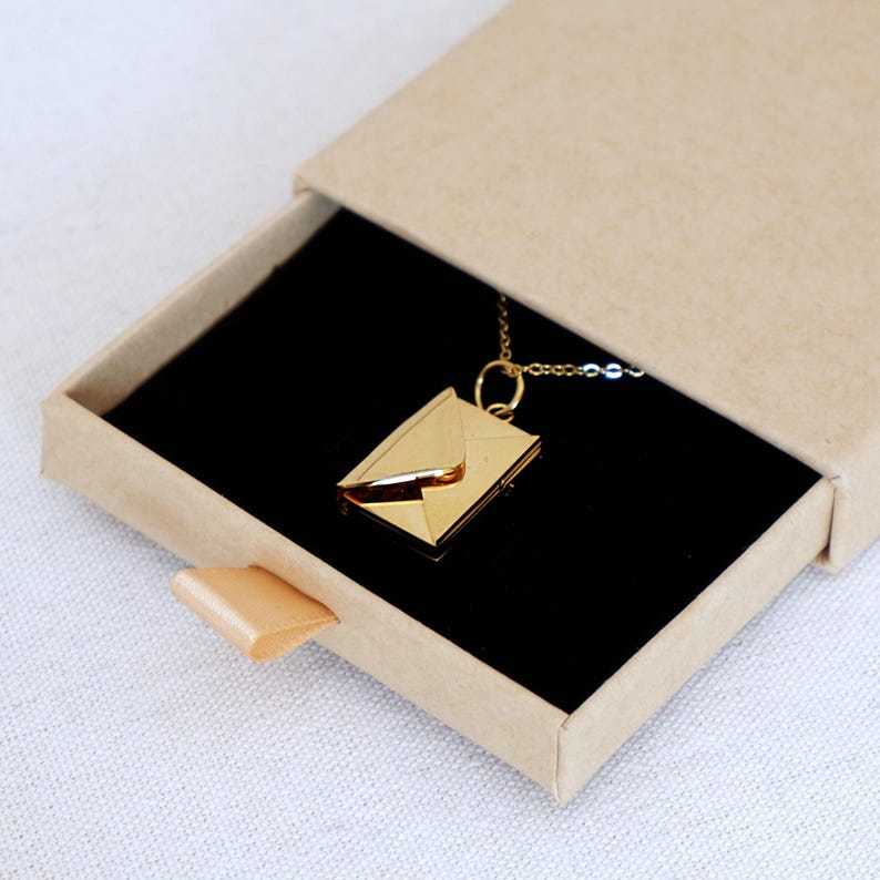Gift-ready packaging of the secret message necklace, with a love note card theme, perfect for an anniversary surprise.