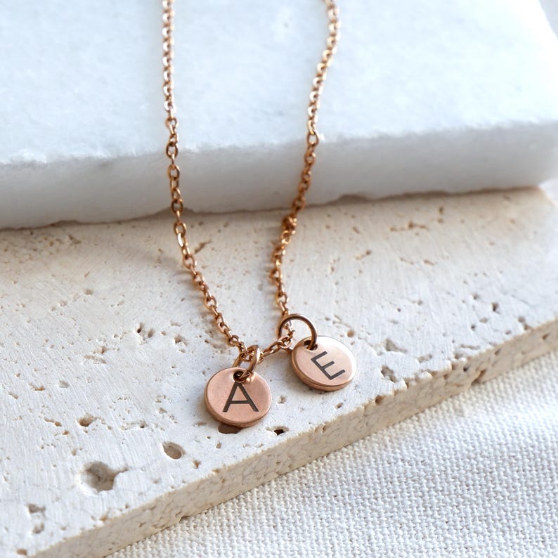 Dainty rose gold initial disc necklace with custom engraved letter A.