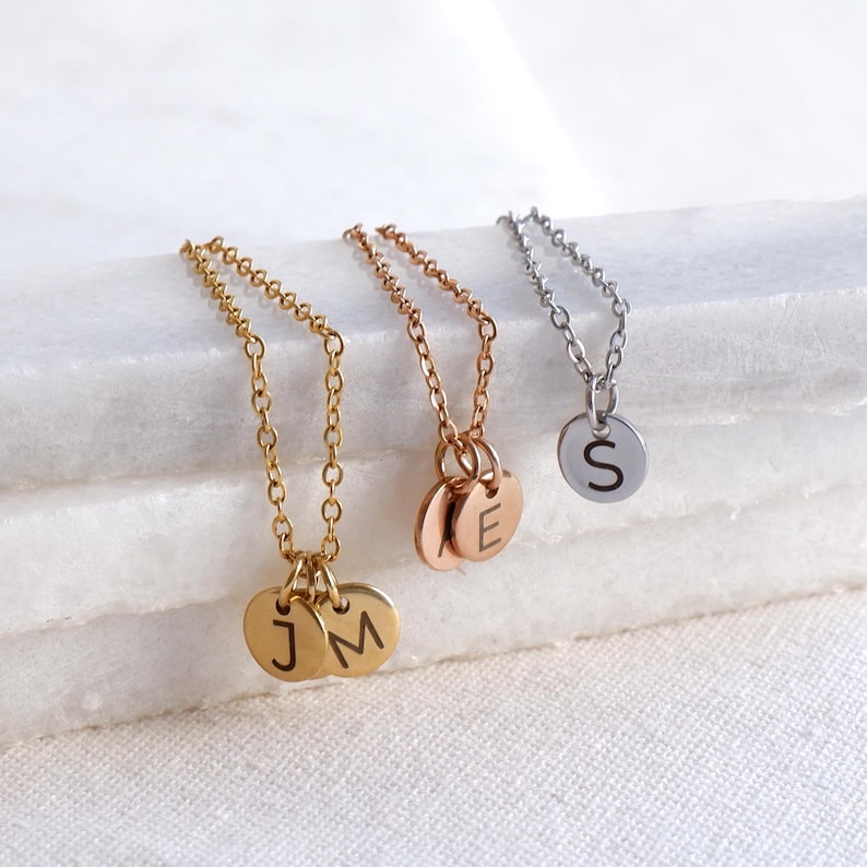 Custom family initials necklace with multiple engraved letter charms on one chain.