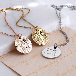 Personalised map and coordinates necklaces displayed with engraved pendant designs