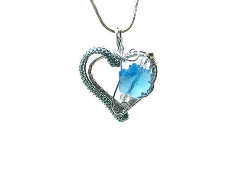 Heart pendant with blue crystal snowflake in silver and blue