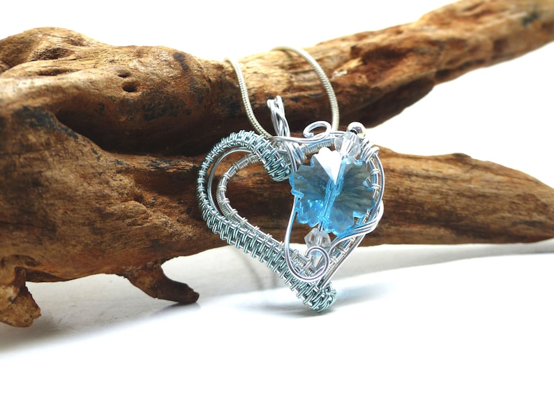 Heart pendant with blue crystal snowflake in silver and blue