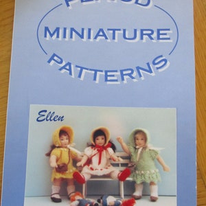 May include: A blue booklet with the title "Period Miniature Patterns" and a photo of three dolls wearing dresses and hats. The dolls are sitting on a bench with two smaller dolls lying on the ground. The text "Ellen" is printed in blue at the top of the photo.
