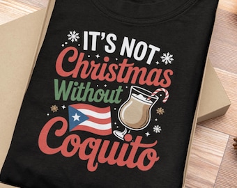May include: Black t-shirt with the text "IT'S NOT Christmas Without Coquito" in white, red, and green. The design includes a Puerto Rican flag and a graphic of a coquito drink with a candy cane.