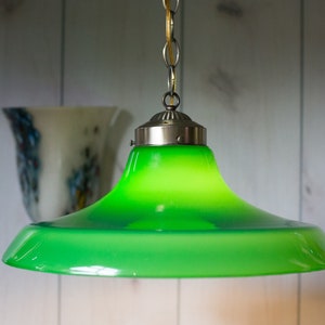 May include: A green glass pendant light fixture with a silver metal canopy and chain.