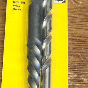 May include: A yellow and blue package with a silver drill bit and a spiral screw extractor. The package says "IRWIN HANSON EX-5 Spiral Screw Extractor" and "HIGH SPEED STEEL DRILL BIT 19/64".
