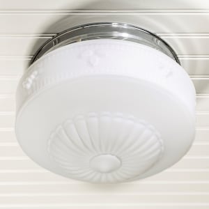 May include: A white ceiling light fixture with a chrome finish and a frosted glass shade with a decorative pattern.