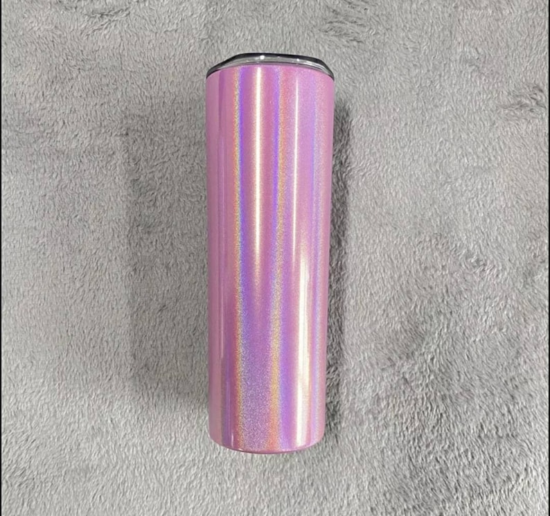 May include: A pink iridescent stainless steel tumbler with a silver lid.