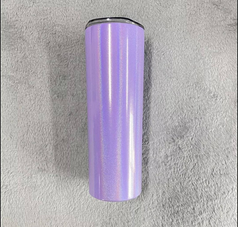 May include: A tall, stainless steel tumbler with a purple iridescent finish. The tumbler has a black lid and a silver band around the top.
